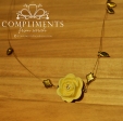 yellow rose pendant on gold leaf necklace